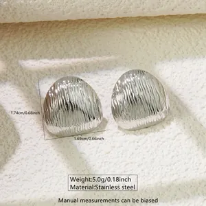 Macro view of geometric stainless steel earrings with wavy texture and dimensions