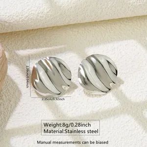 Detail of silver wavy round earrings showing 2.39cm size and stainless steel texture