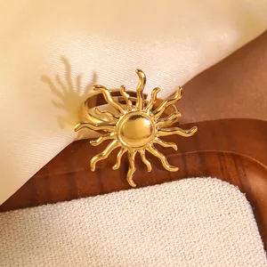 Macro detail of golden sunburst ring with adjustable band on a warm texture background