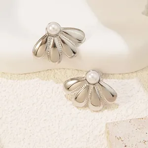 Macro shot of silver flower earrings with white pearl and beaded edge detail