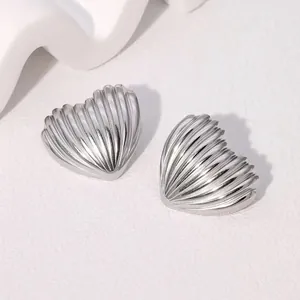 Detailed view of silver heart stud earrings featuring a unique vertical crinkle texture