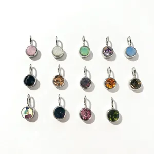 Macro shot of 14 colorful 8mm round birthstone charms in stainless steel frames
