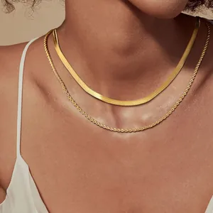 Detailed close-up of double-layered gold stainless steel snake and rope chain necklaces