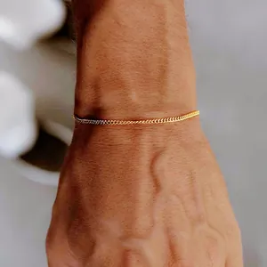 Minimalist gold curb chain bracelet for women on wrist featuring an adjustable design