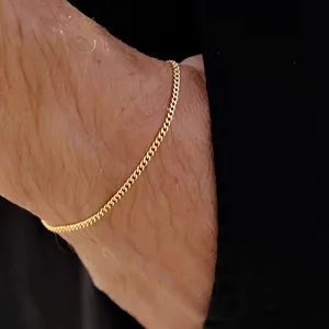 Elegant gold Cuban link chain bracelet on wrist featuring adjustable minimalist style