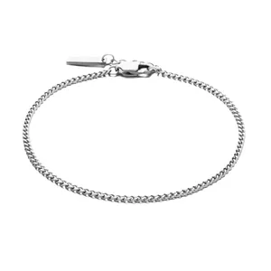 Polished silver stainless steel Cuban link bracelet with lobster clasp on white background