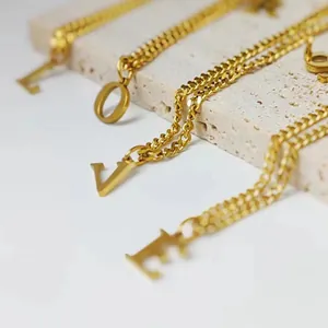 Golden 14K stainless steel curb chain necklace featuring LOVE letter pendants on stone