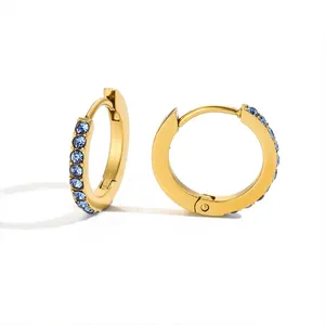 Polished gold huggie earrings with embedded blue rhinestones on a white background