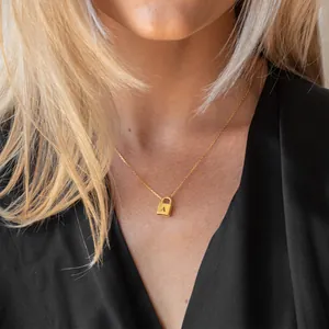 Golden stainless steel necklace featuring a square lock pendant with engraved letter A