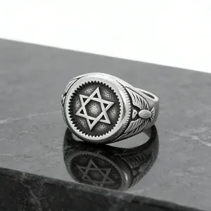 Macro shot of retro stainless steel ring with hexagram symbol and detailed side wings
