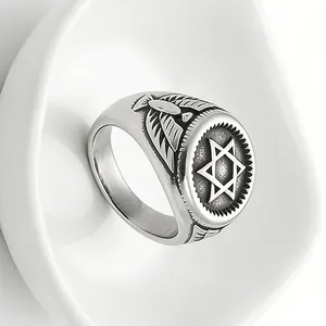 Detailed view of vintage stainless steel eagle ring with hexagram pattern on silver band