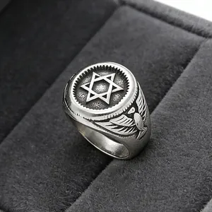 Macro shot of vintage steel eagle ring with hexagram design in a velvet box