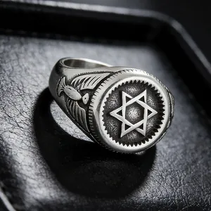 Macro shot of vintage steel ring featuring hexagram carving and eagle side relief