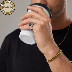 Men's stainless steel Yin Yang ring, gold Cuban chain, and necklace set in lifestyle scene