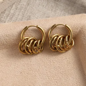Macro shot of gold stainless steel hoop earrings with five hanging small rings