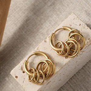 Macro shot of gold-plated titanium steel hoop earrings with stacked small rings