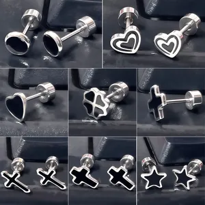Macro detail of titanium steel stud earrings with black enamel shapes and screw backs