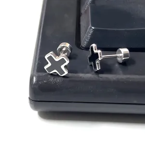 Close-up of cross-shaped titanium steel studs with black enamel and screw-back design