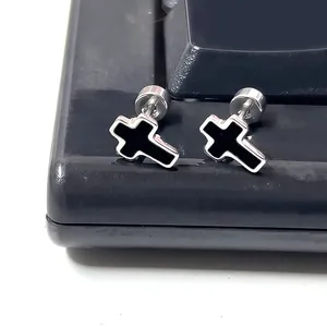 Macro shot of titanium steel cross stud earrings with black enamel and screw back detail