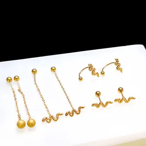 Detail view of golden stainless steel snake earrings with fine scale texture and shiny finish