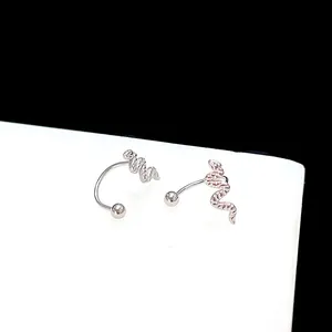 Macro shot of silver snake earrings with detailed scale texture and ball closure