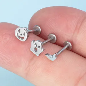Macro view of stainless steel Halloween labret set with pumpkin ghost and bat designs