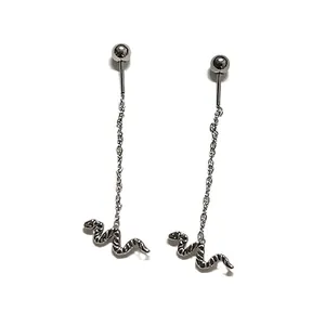 Detail of silver snake drop earrings with long chains and engraved scale texture