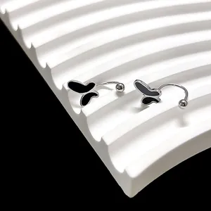 Detail van zilveren vlinder oorbellen met zwart emaille en schroefsluiting met bolletje