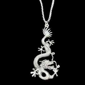 Macro shot of silver dragon pendant necklace with detailed scales and vintage finish