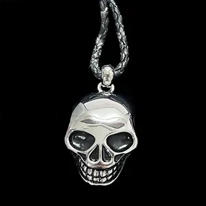 Close-up of gothic silver skull pendant with vintage finish on black woven cord
