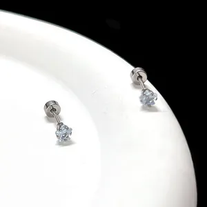Détail des boucles d'oreilles étoiles en acier titane argenté avec zircon bleu