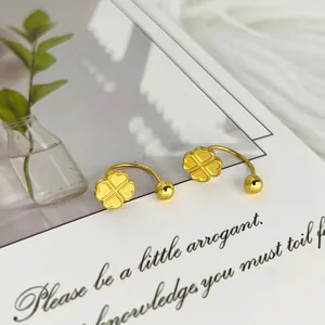 Detailansicht der goldenen Kleeblatt Ohrstecker auf Deko-Karte mit gebogenen Stahlstiften