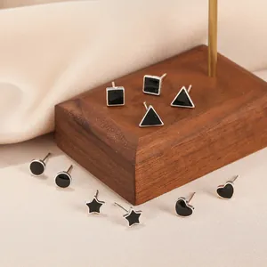 Set of minimalist black geometric enamel stud earrings including heart and star shapes