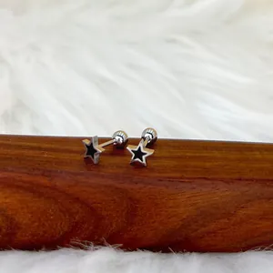 Gros plan sur les boucles d'oreilles étoile avec émail noir et fermoir à vis
