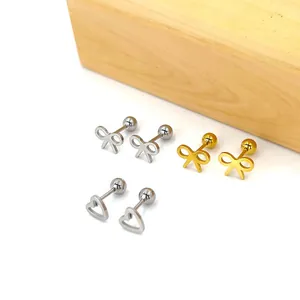 Macro shot of stainless steel bow and heart stud earrings with secure ball screw backings