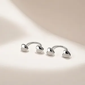 Minimalist silver horseshoe heart earrings with polished finish and screw-on closure