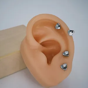 Detailed view of silver heart U-shaped screw back earrings on an ear model