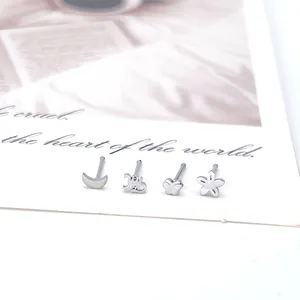Polished silver nose studs set featuring moon, butterfly, and flower designs on card