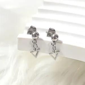 Close-up of geometric hollow triangle earrings in polished stainless steel finish