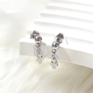 Detail of silver Hamsa skull hollow earrings in titanium steel with punk style design