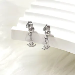 Close-up of silver titanium steel crown drop earrings on a white textured stand