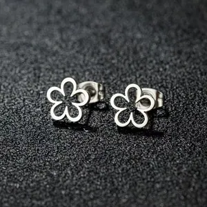 Minimalist silver flower stud earrings in hollow five-petal design on display stand