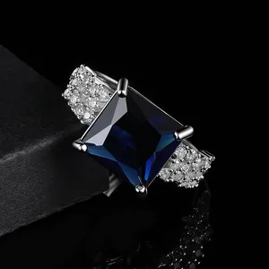Luxurious silver ring with square blue sapphire and pave zircon side stones