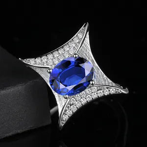 Luxury sapphire blue oval engagement ring with white micro diamonds in silver finish