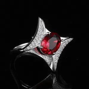 Vintage luxury engagement ring with oval red ruby and sparkling zircon accents