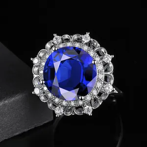 Macro shot of luxury blue oval gemstone ring with diamond halo and镂空 detailing