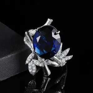 Exquisite gold ring with oval blue sapphire and bamboo leaf diamond-encrusted band