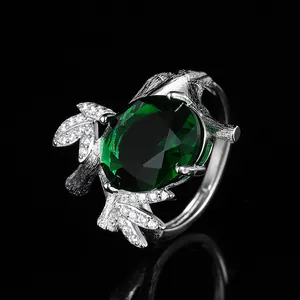 Luxury bamboo-textured gold ring with large oval green gemstone and white zircon accents