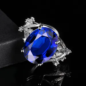 Luxury oval blue sapphire ring with vine texture and sparkling diamond accents