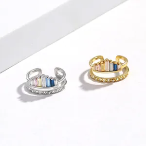 Close-up of rainbow crown ring with colorful cubic zirconia and retro engravings